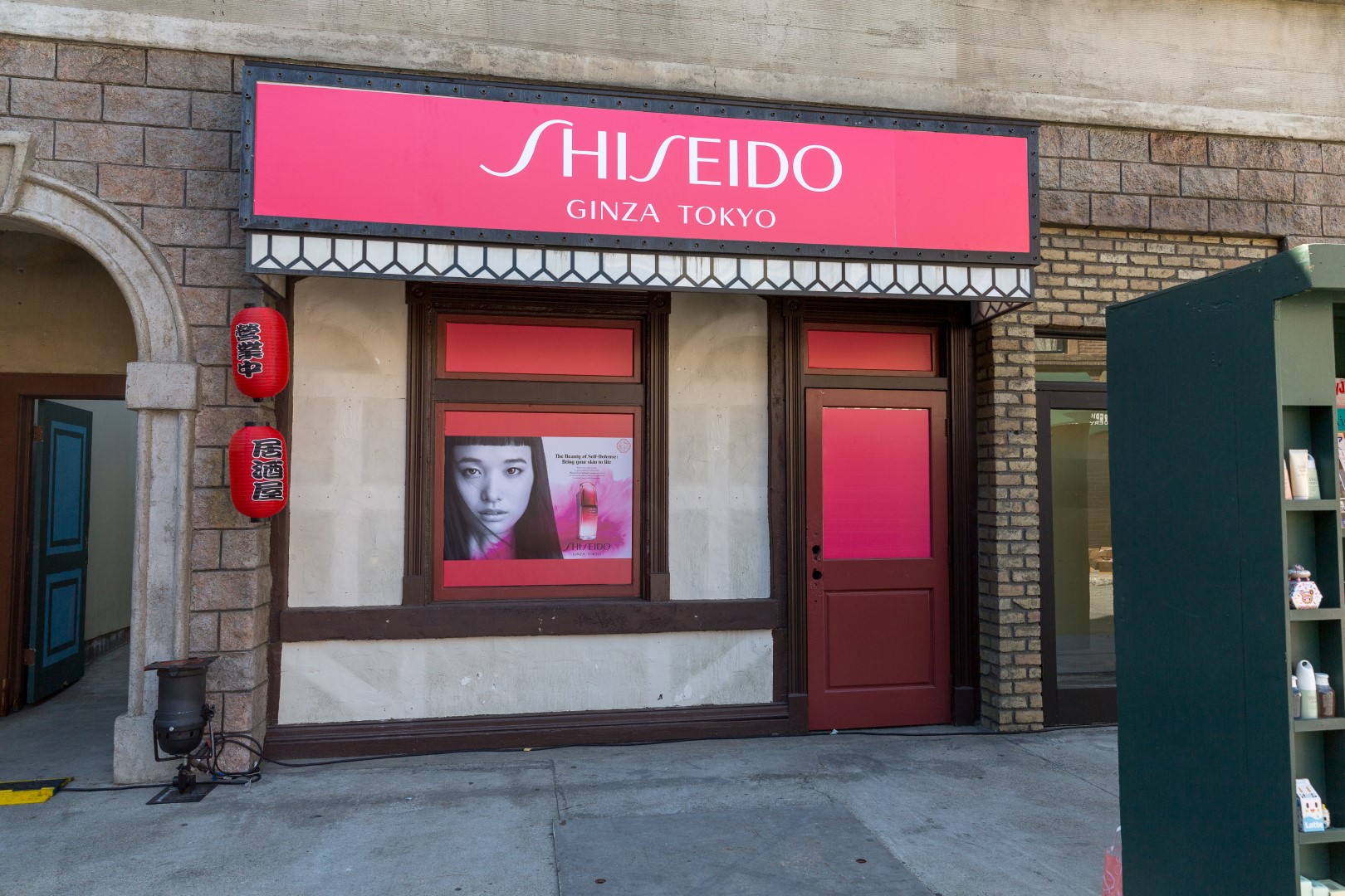 Shiseido store front featuring vibrant pink signage and promotional artwork.