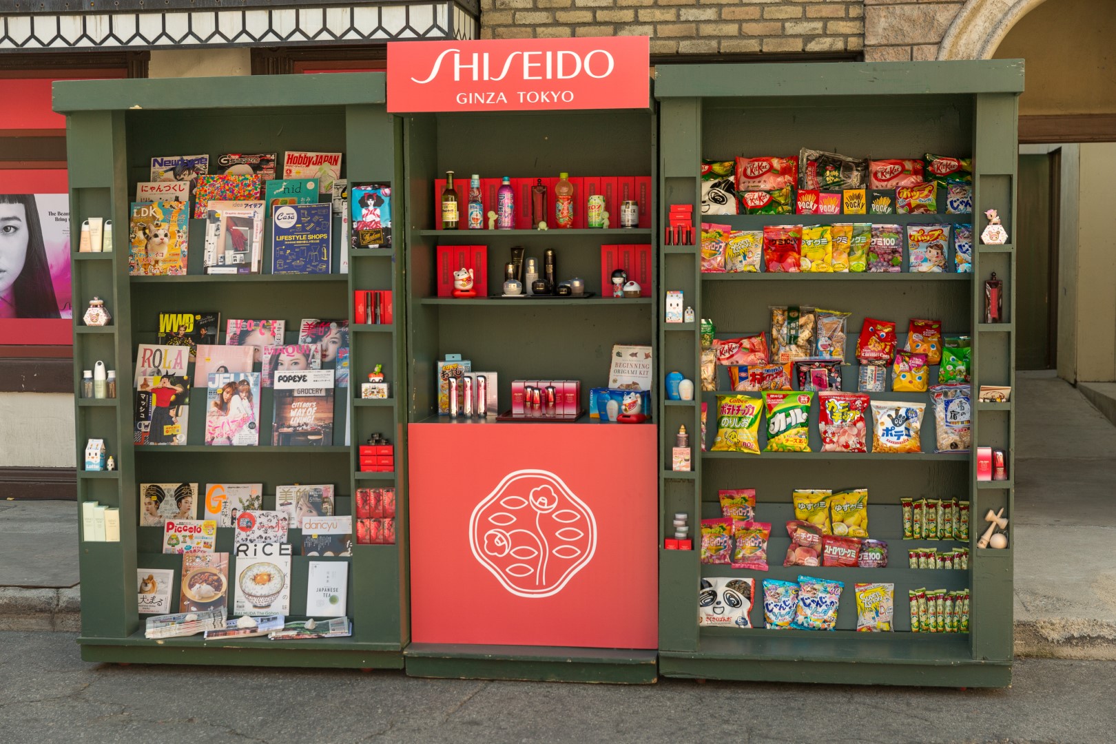 A vibrant Shiseido display featuring cosmetics, magazines, and Japanese snacks.