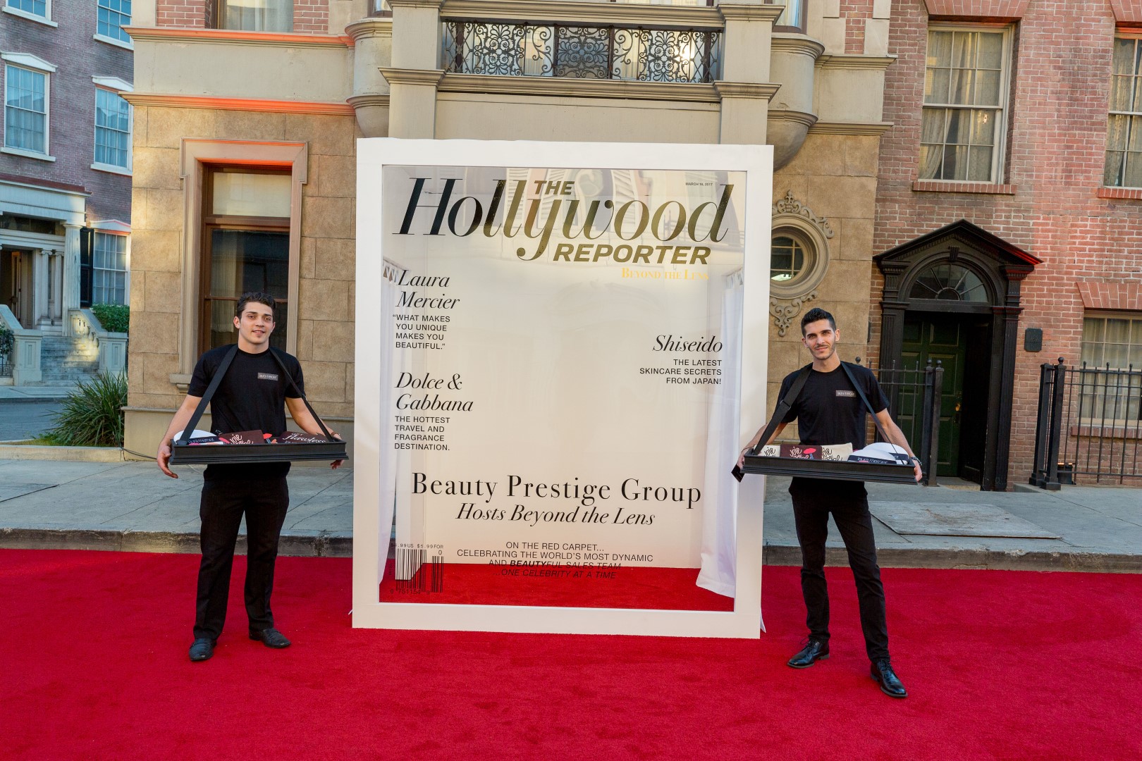Event at The Hollywood Reporter featuring models with trays at a red carpet beauty showcase.