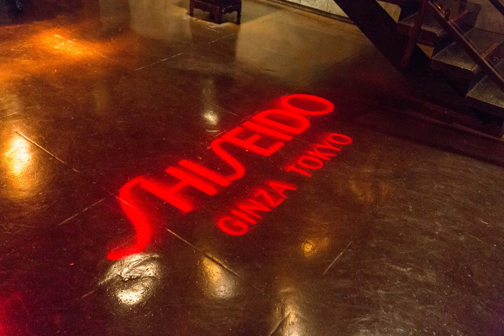 Shiseido Ginza Tokyo logo projected on a polished floor surface