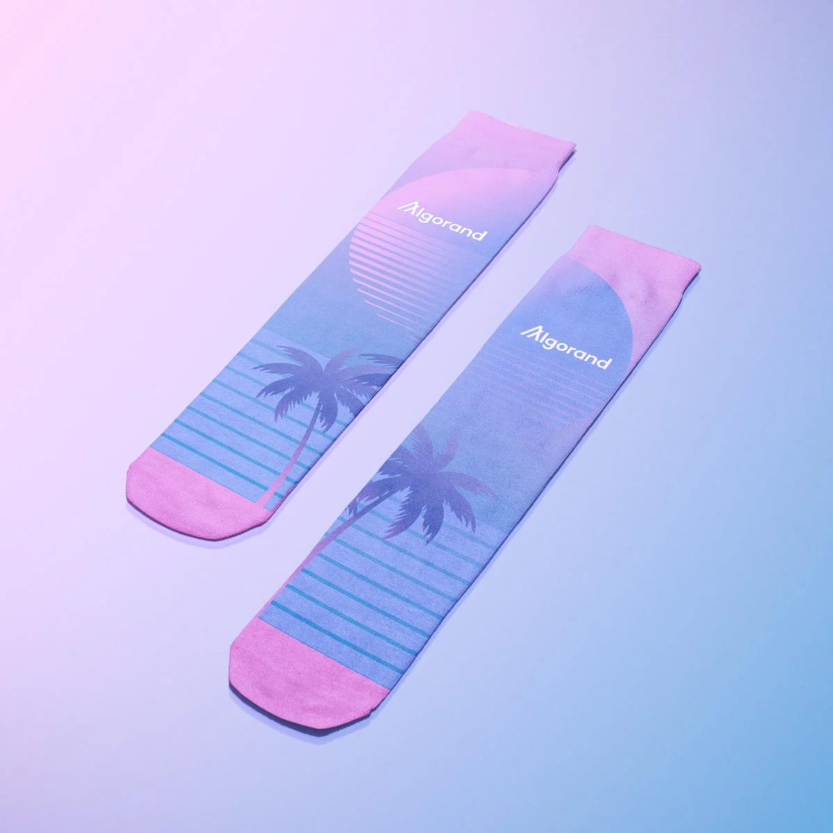 Stylish Algorand socks with a vibrant sunset and palm tree design in pink and blue tones.