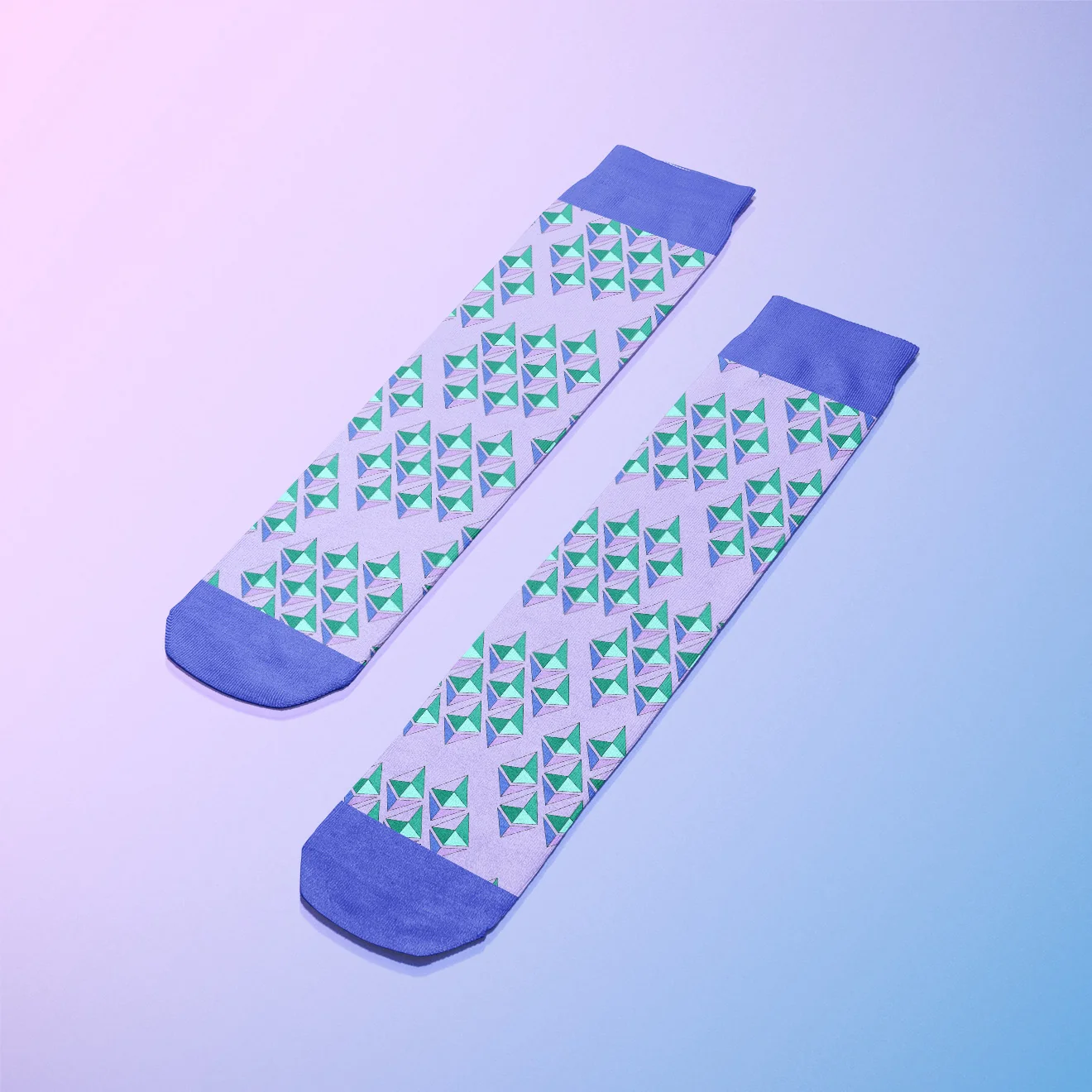 Stylish patterned socks with green and blue geometric designs on a pastel background.