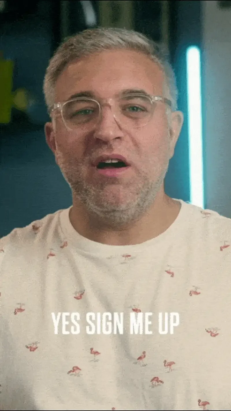 Man enthusiastically expressing eagerness to sign up, wearing a flamingo-patterned shirt.