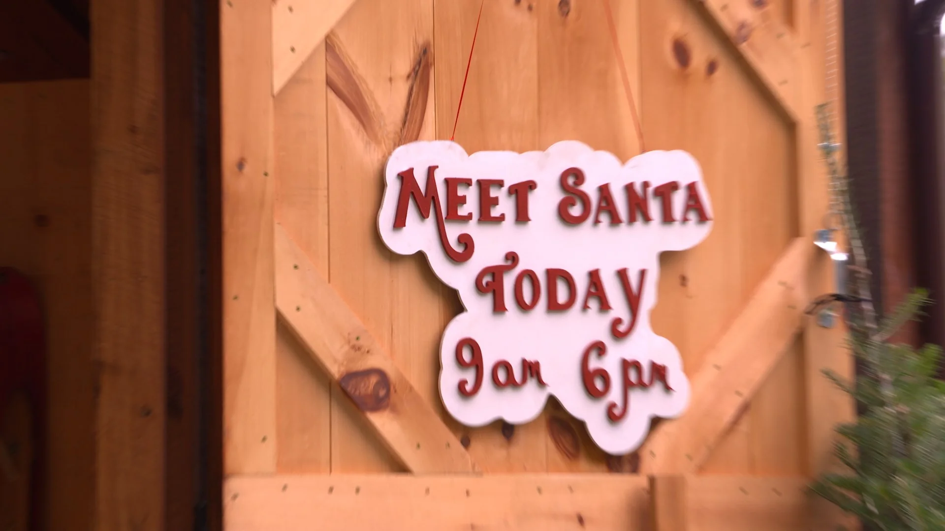 Sign announcing Santa's availability today from 9 AM to 6 PM.