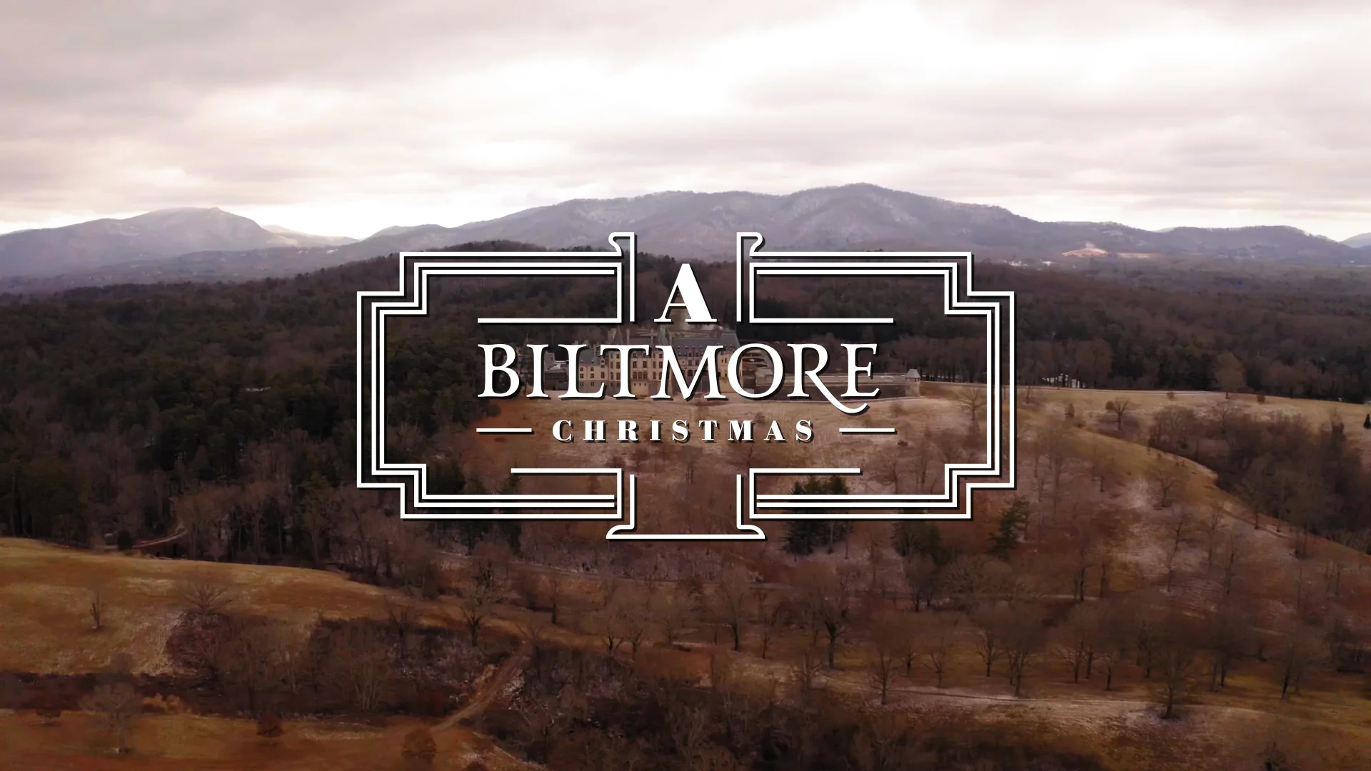 A Biltmore Christmas logo over a scenic mountain landscape.