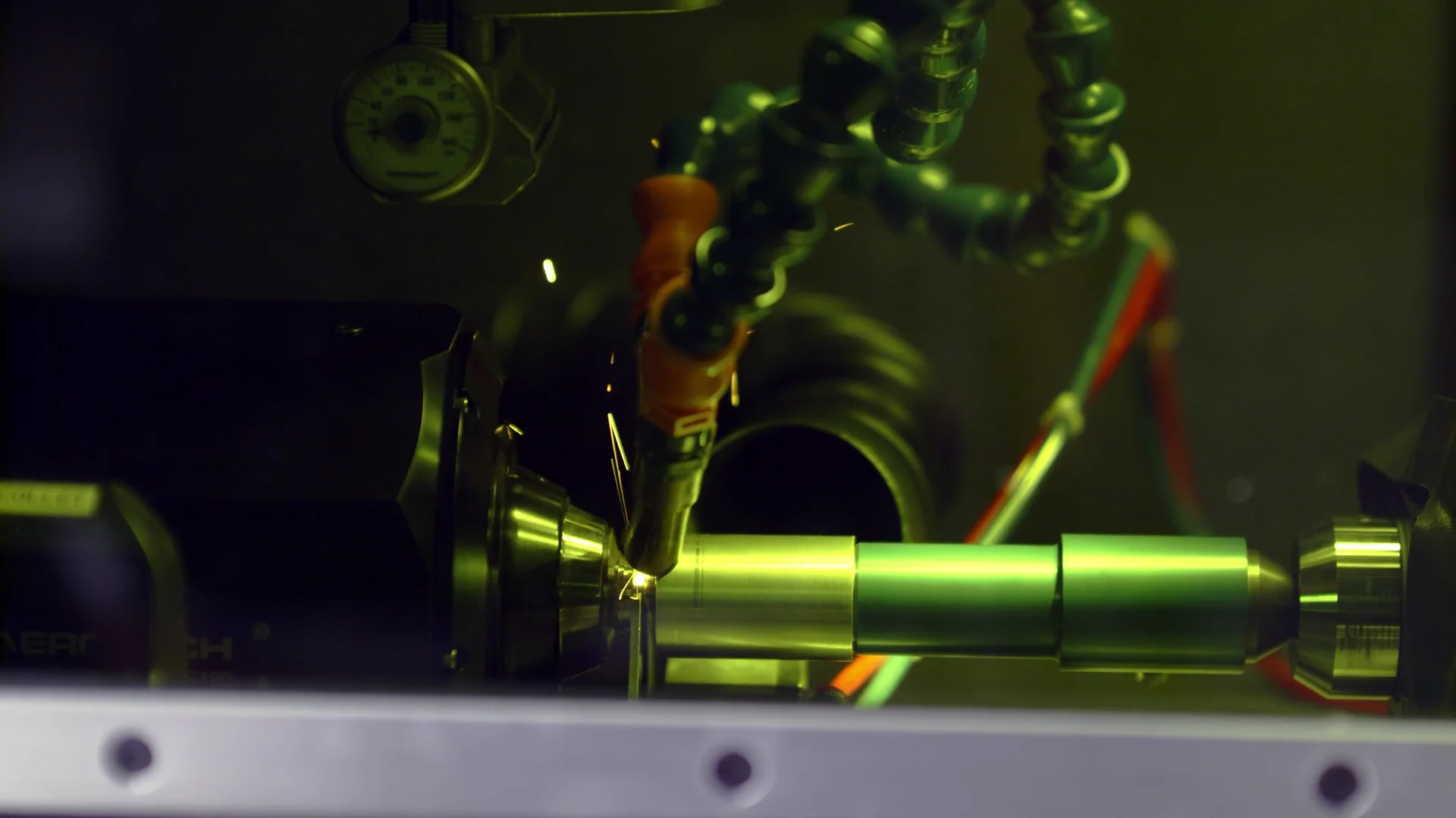 Close-up of a CNC machine with a welding torch in operation.