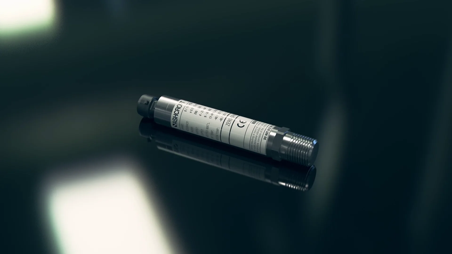 Ashcroft E2G Transducer with a label lying on a reflective surface