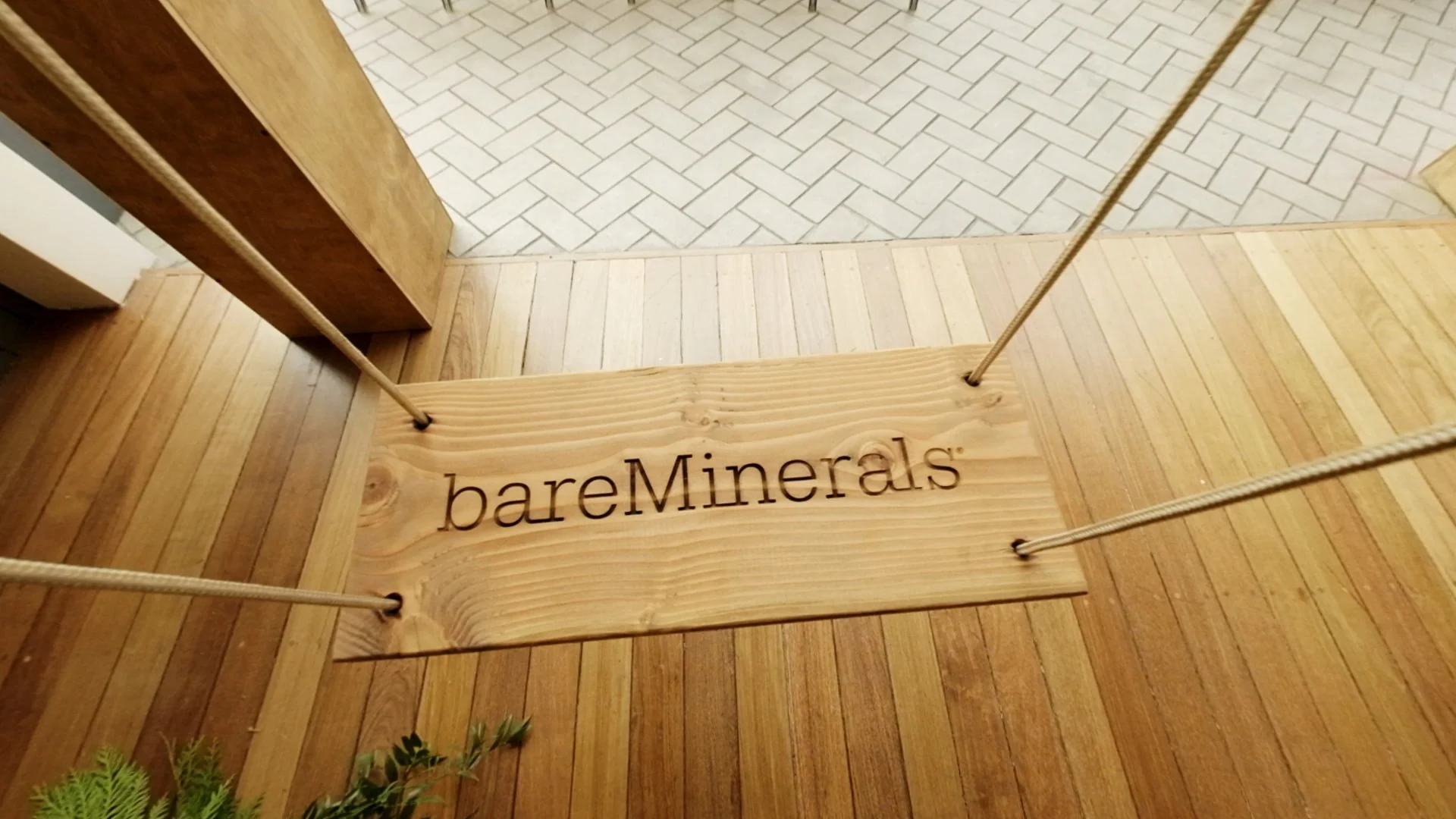 Wooden swing with 'bareMinerals' logo displayed