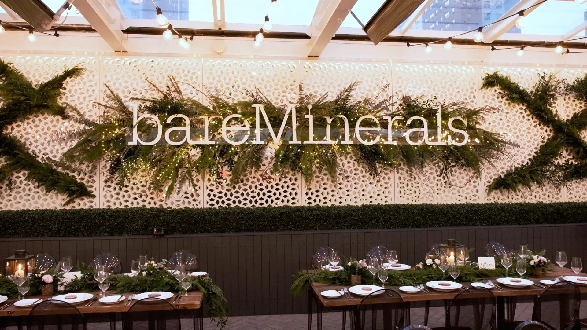 Event setup with bareMinerals sign and decorated dining tables