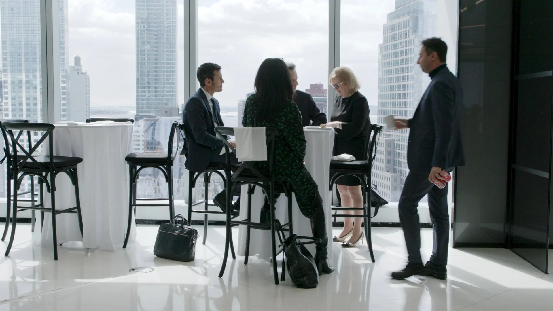 Business professionals having a meeting in a high-rise office with a city view.