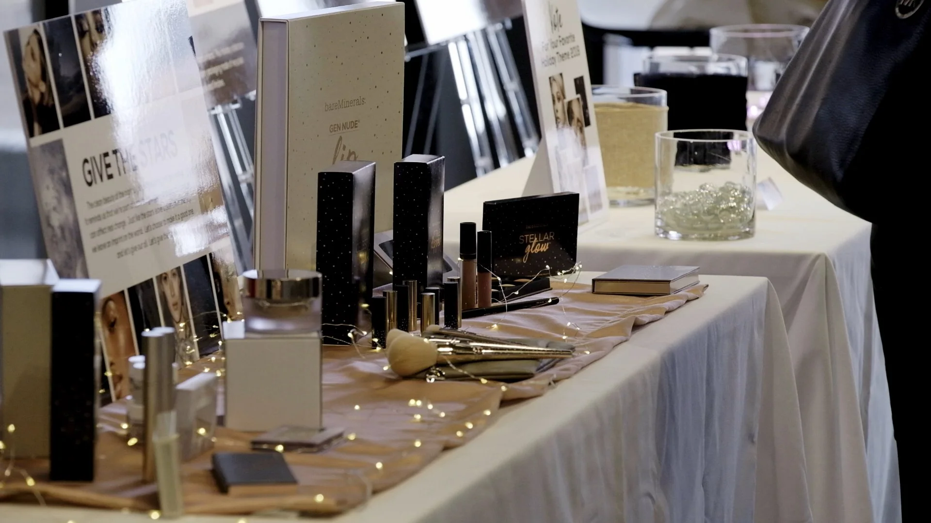 Cosmetics display with various beauty products and packaging on a table.