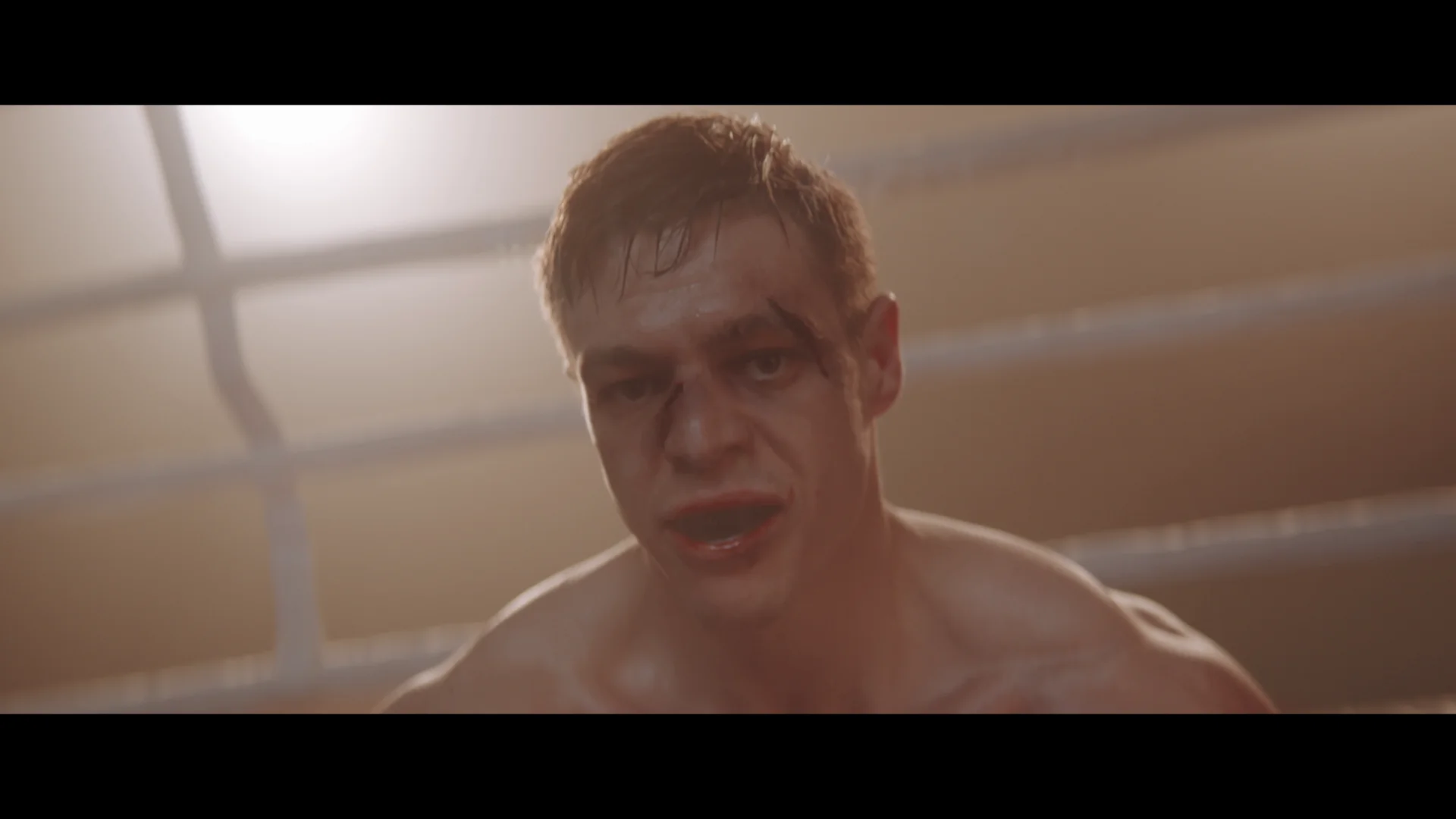 A focused boxer with cuts and bruises, standing in a boxing ring, embodying determination and resilience.